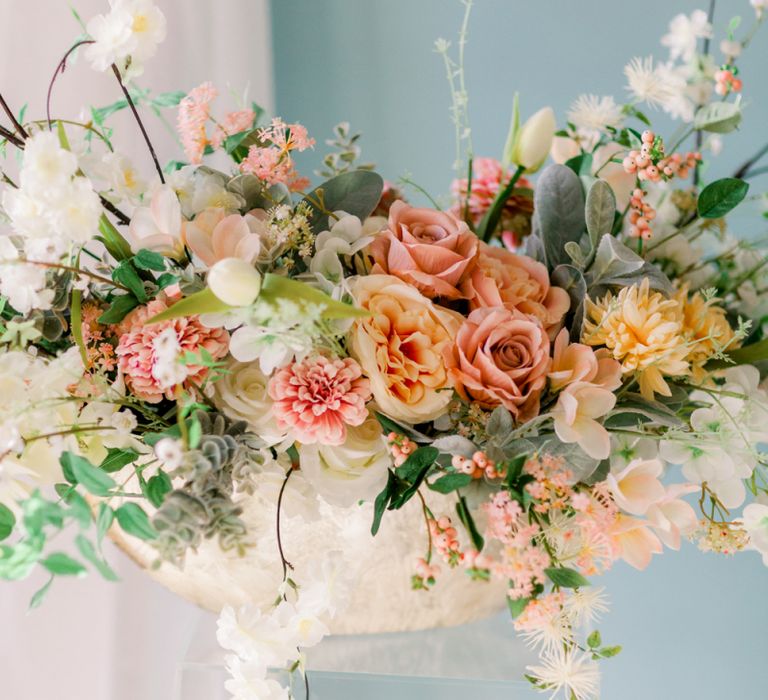 Peach and coral wedding flower arrangement