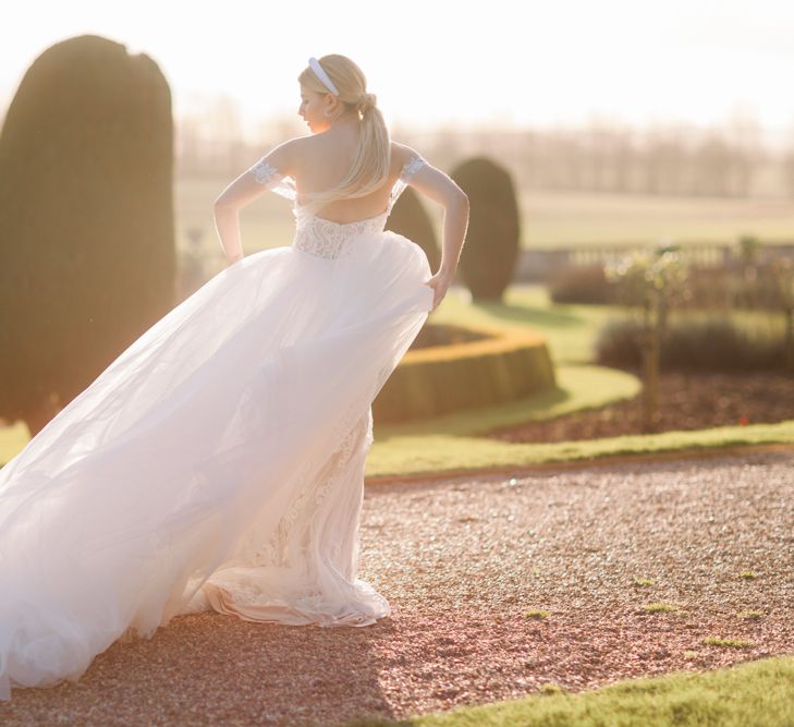 Golden hour portrait with bride in blush tulle wedding dress