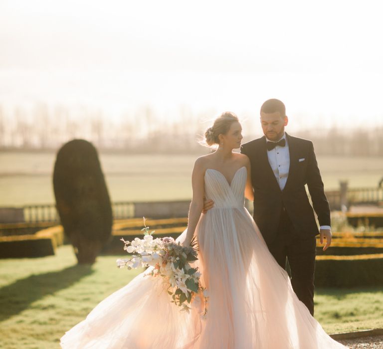 Sunset portrait with bride and groom in black tie attire