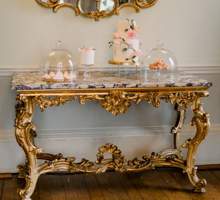 Dessert table with wedding cakes and individual desserts