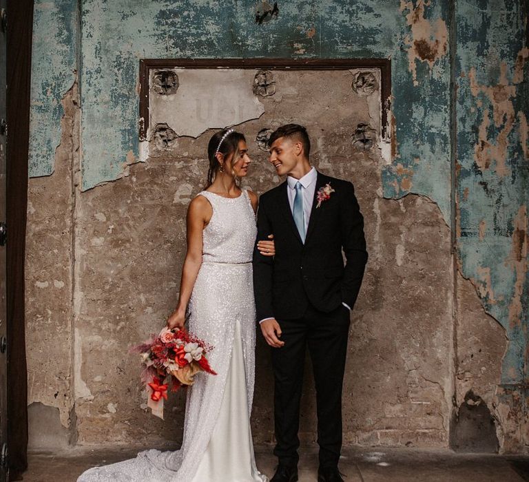 Stylish Bride and Groom in the Asylum Chapel with pink wedding jacket