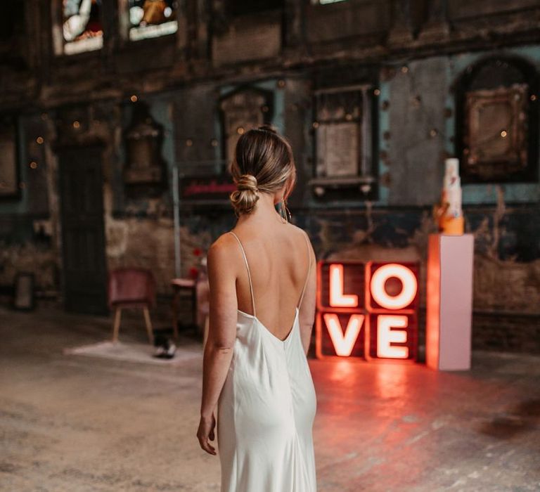 Bride in Low Back Satin Wedding Dress with Bridal Bun