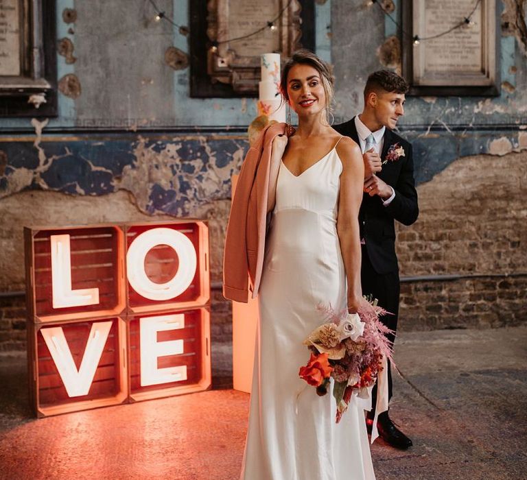 Bride in Minimalist Wedding Dress and Pink Wedding Jacket