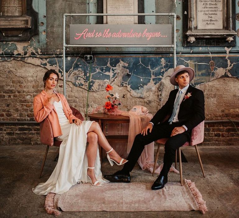 Bride and Groom Relaxing at the Seating Area with Bride in Pink Wedding Jacket