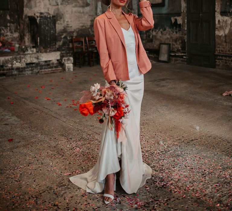 Contemporary Bride in Satin Wedding Dress, Pink Wedding Jacket and Fedora Hat