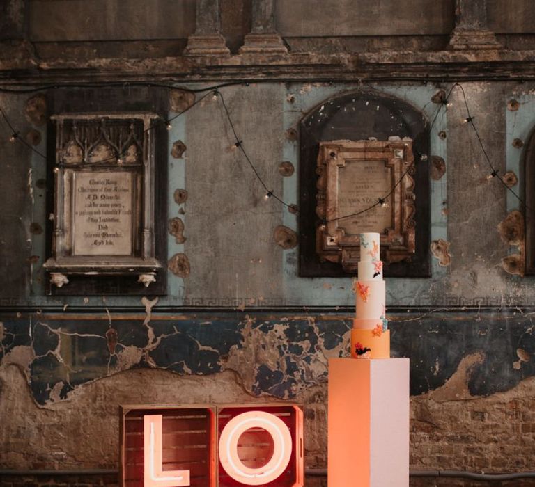 LOVE Neon Sign with Tall Wedding Cake on a Plinth