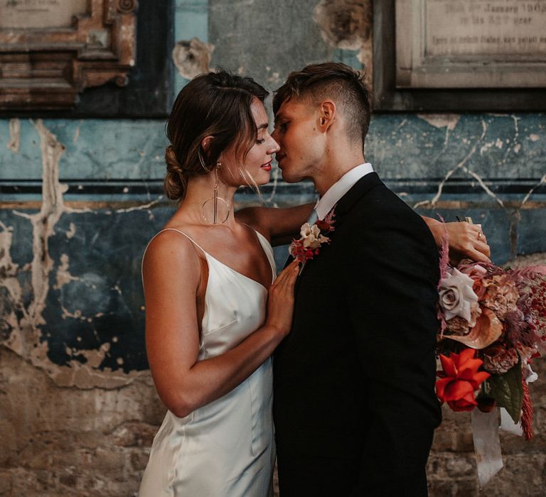 Bride and Groom Kissing Under Festoon Lights