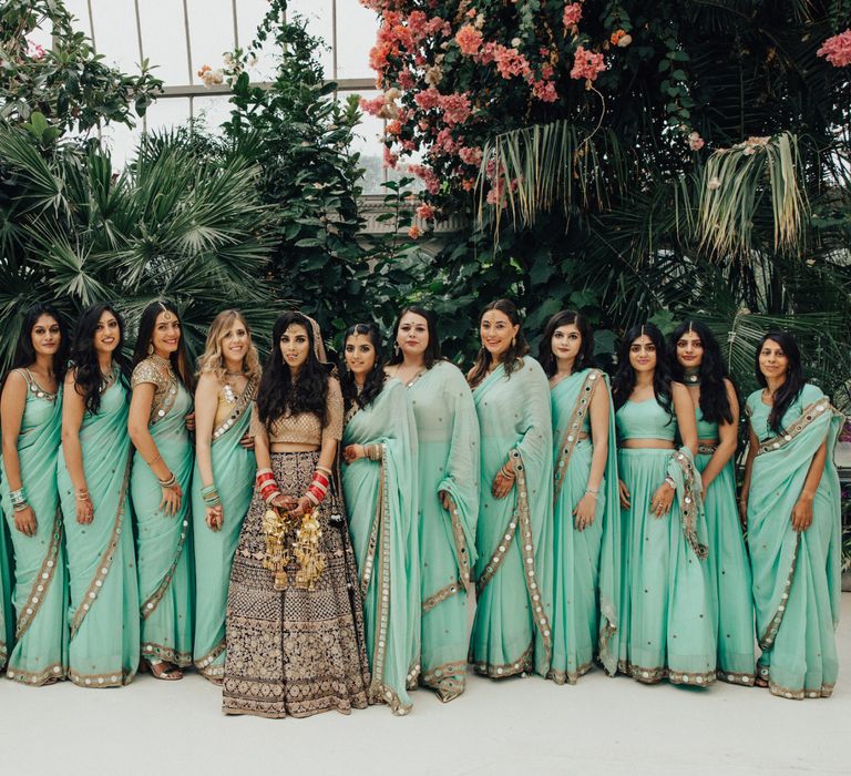 Bridal Party with Bride in Navy &amp; Gold Saree and Bridesmaids in Mint Green Sarees