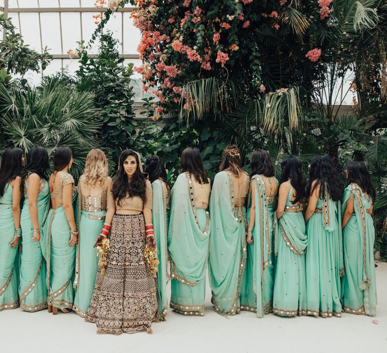 Bridal Party with Bride in Navy &amp; Gold Saree and Bridesmaids in Mint Green Sarees