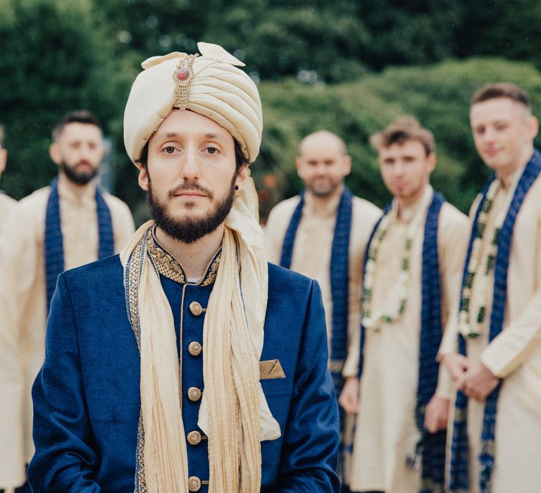 Groom in Navy and Gold Indian Wedding Suit with Turban