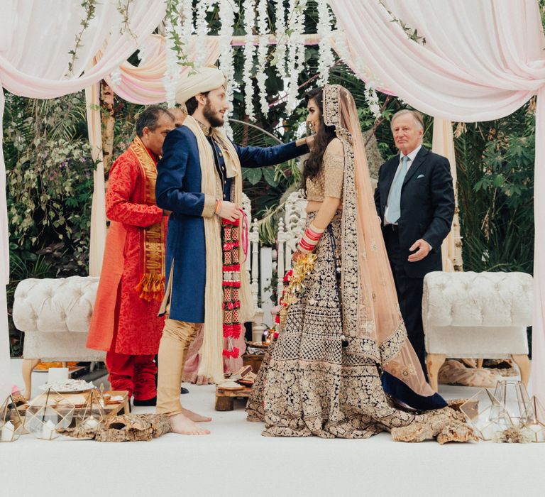 Indian Bride and Groom Exchanging Vows Under a Mandapa Mandap