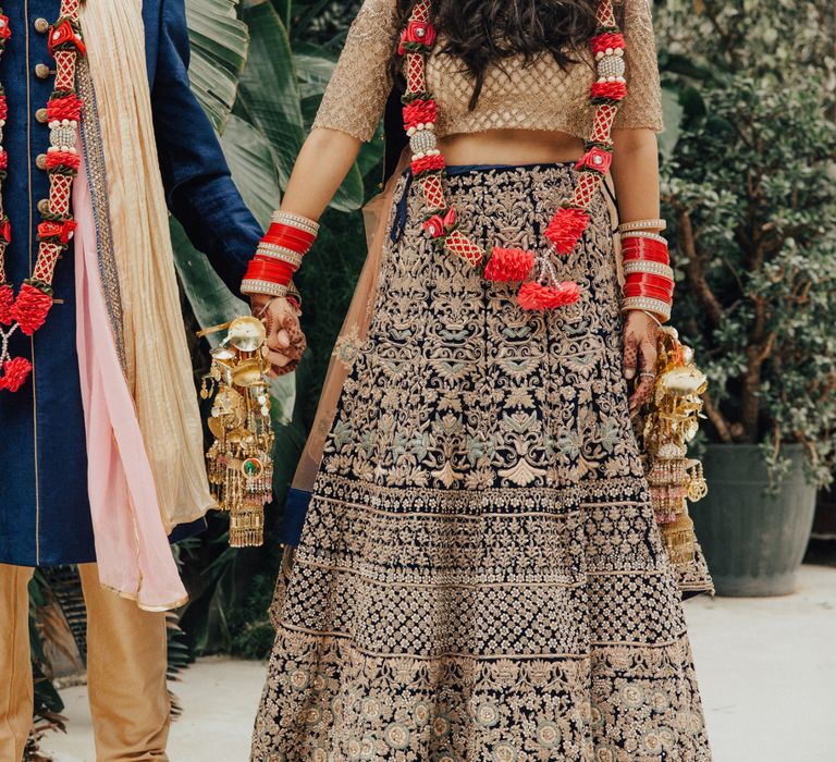 Bride and Groom Gold and Navy Traditional Hindu Wedding Attire