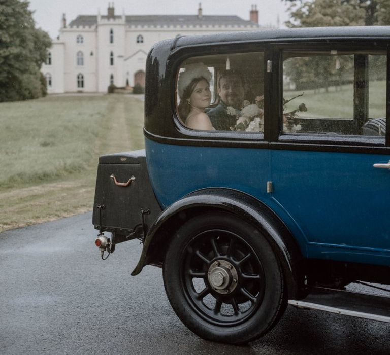 Bride and Groom in Vintage Wedding Car