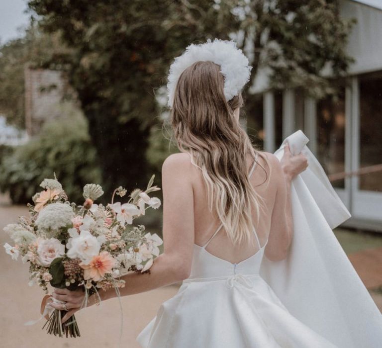 Bride in Spaghetti Strap Wedding Dress Holding a Blush Pink and White Bouquet