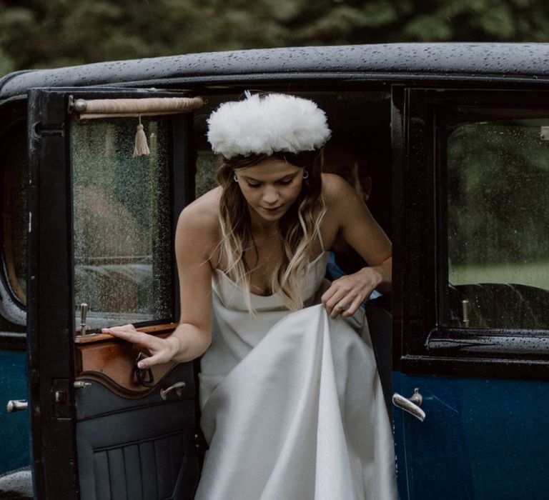 Bride in Emma Beaumont Wedding Dress and Headdress Getting out Of the Vintage Wedding Car