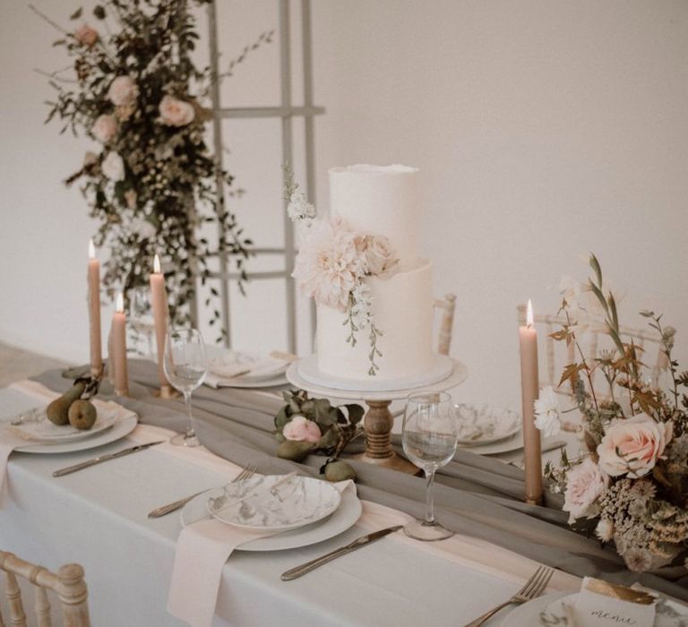 Romantic Blush Pink, White and Grey Tablescape with Two Tier Wedding Cake and Candles