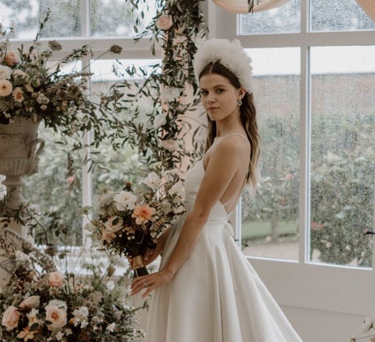 Bride in Emma Beaumont Wedding Dress with Thin Straps and White Headdress