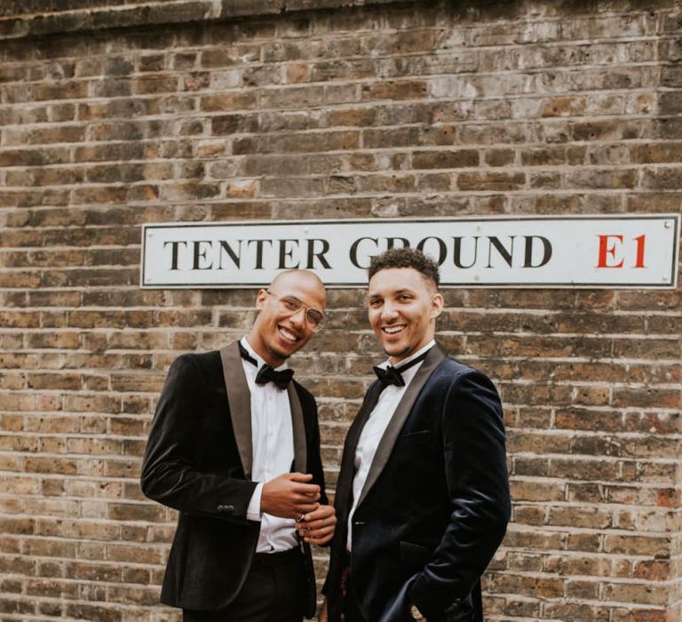 Groom and best man in navy velvet dinner jackets and bow ties