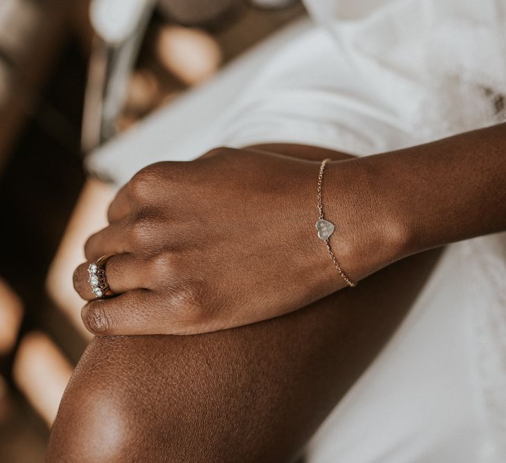 Black bride wearing a delicate heart bracelet