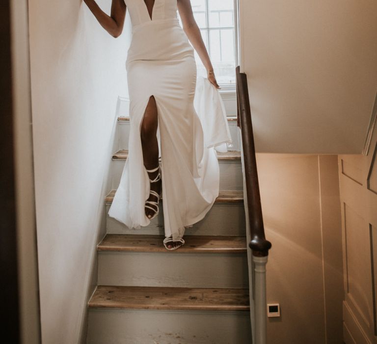 Black bride in Made With Love Bridal gown walking down the stairs