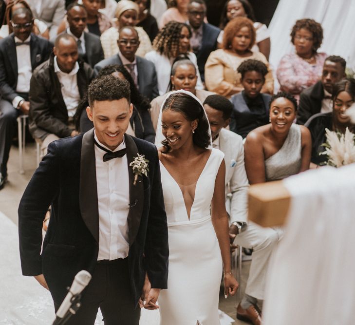 Bride and groom smiling during their wedding ceremony