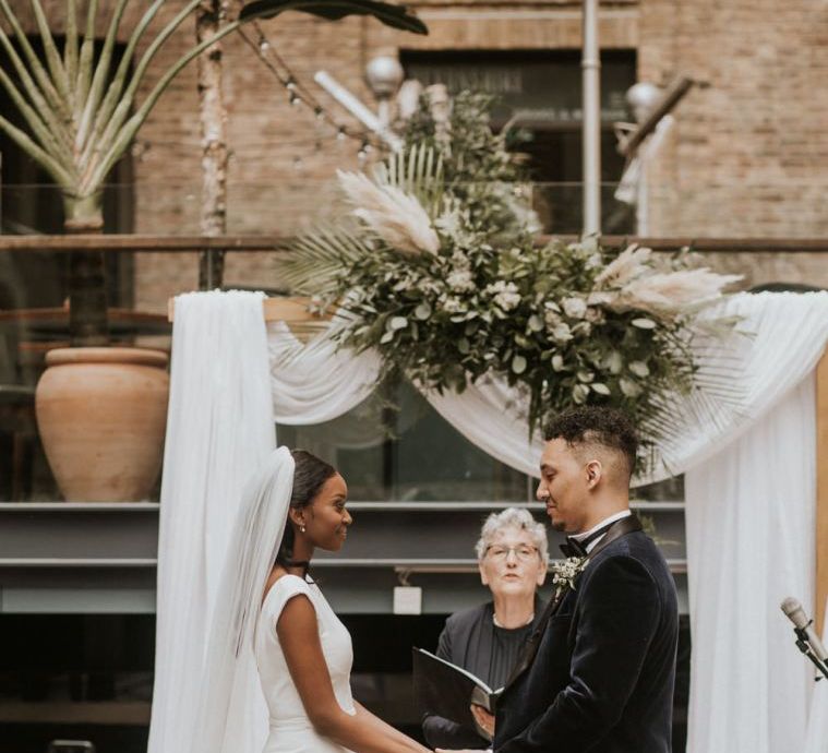 Black bride and groom exchanging vows at their Devonshire Terrace wedding ceremony