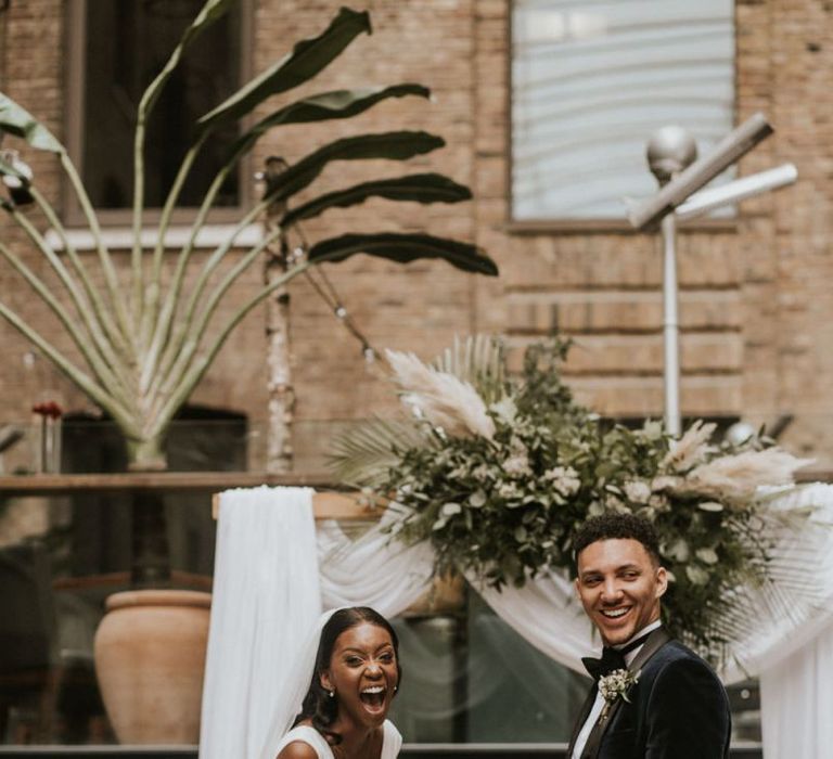 Happy bride and groom during rooftop wedding ceremony