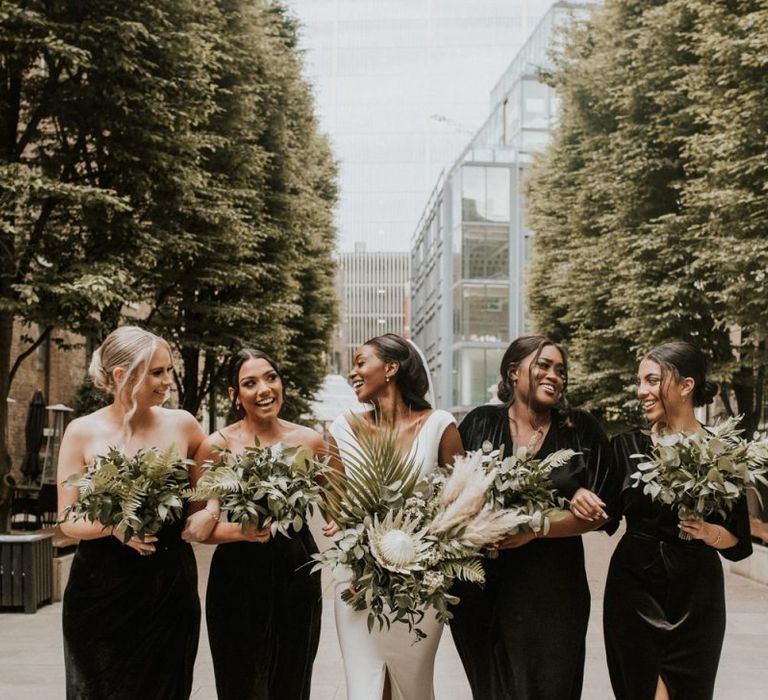 Bridesmaids in black velvet dresses for stylish Devonshire Terrace wedding