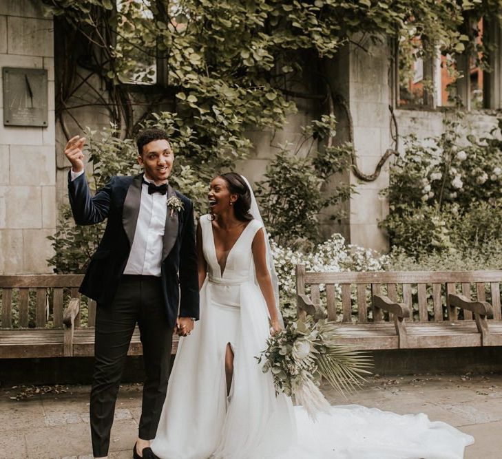 Happy bride and groom wedding portrait at St Dunstans in the East