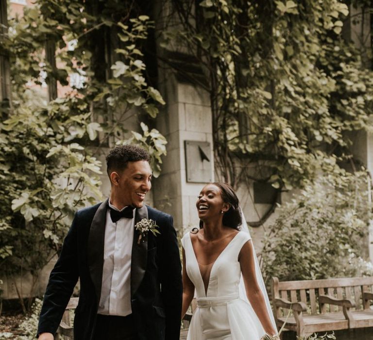 Stylish bride and groom laughing during their St Dunstans in the East wedding portraits