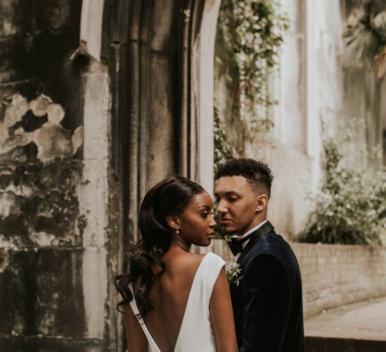 Black bride with backless wedding dress and long wavy hair