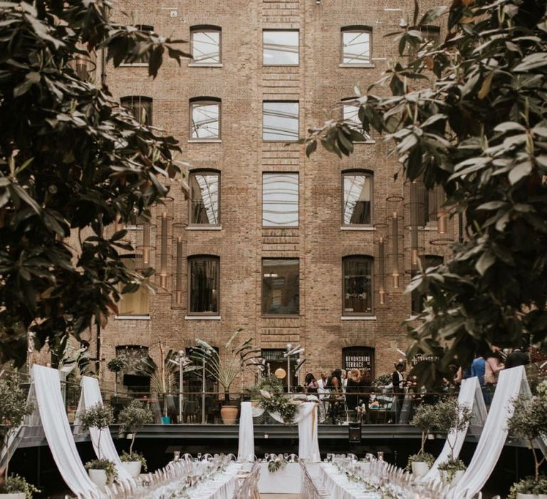 Devonshire Terrace wedding reception with drapes and ghost chairs