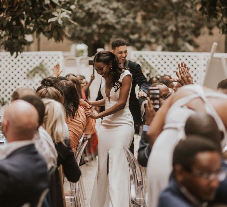 Bride and groom entering the Devonshire Terrace wedding breakfast