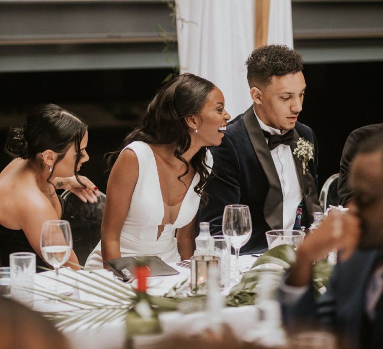 Bride and groom laughing during the Devonshire Terrace wedding speeches