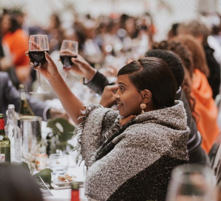 Wedding guests wrapped in blankets at Devonshire Terrace wedding reception