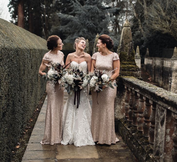 Bride &amp; Bridesmaids In Winter Wedding Attire // Bride In Alice Dress By Watters // Christmas Pub Wedding At The Falcon Rotherwick With Bride In Alice By Watters And Candle Lit Wedding Ceremony Images By Rebecca Searle Photography