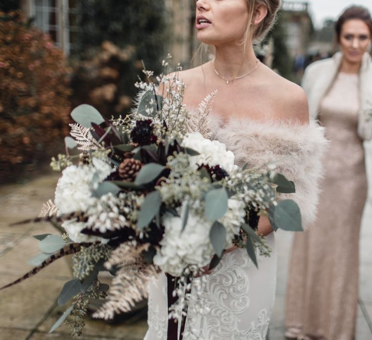 Winter Wedding Bouquet // Christmas Pub Wedding At The Falcon Rotherwick With Bride In Alice By Watters And Candle Lit Wedding Ceremony Images By Rebecca Searle Photography