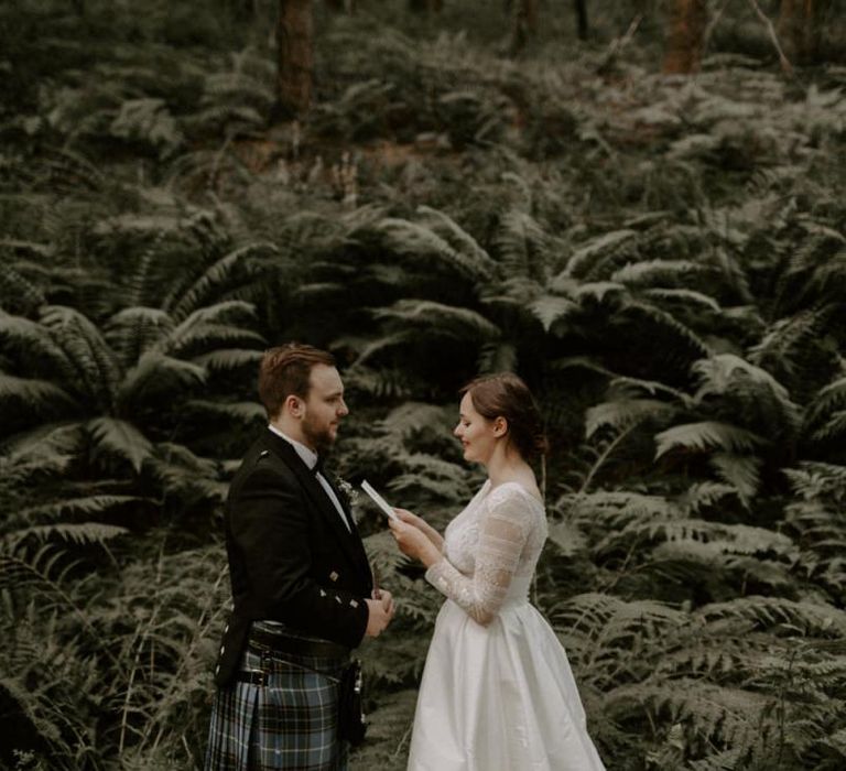 Bride and Groom Exchange Personal Vows In Woods