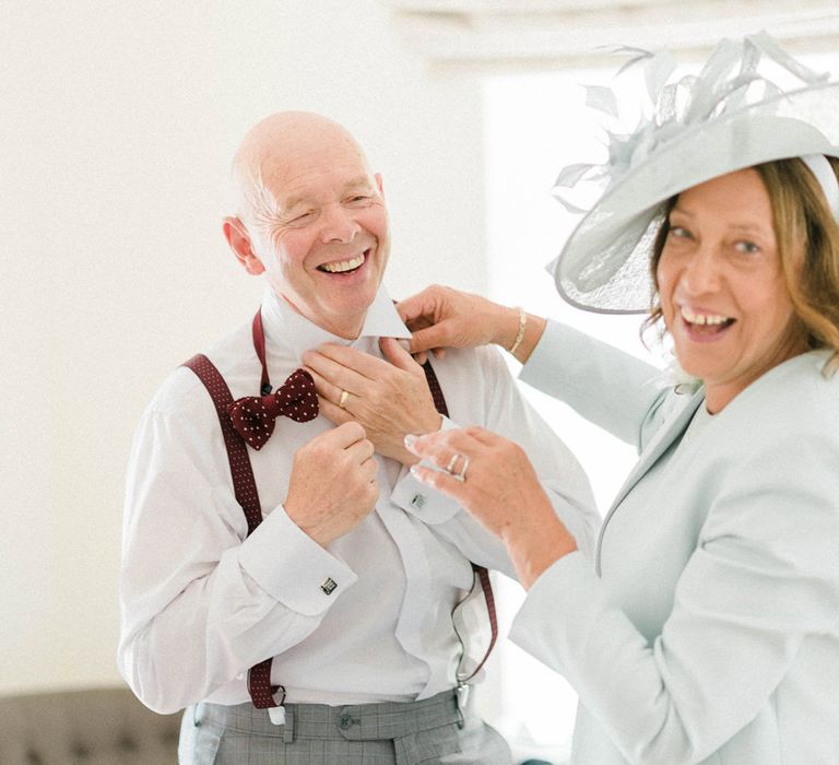 Mother of the Bride in Pale Blue Jacket and Hat | Father of the Bride in Grey Suit with Burgundy Braces, Bow Tie and Brogues | Country Tipi Wedding with Macramé Arch and Hanging Flowers | Sarah-Jane Ethan Photography