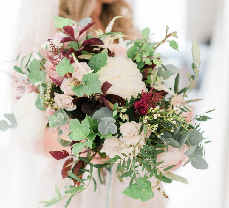 Oversized Bridal Bouquet of White Peonies, Blush Astlibe, Trailing Greenery and Burgundy Eucalyptus | Country Tipi Wedding with Macramé Arch and Hanging Flowers | Sarah-Jane Ethan Photography