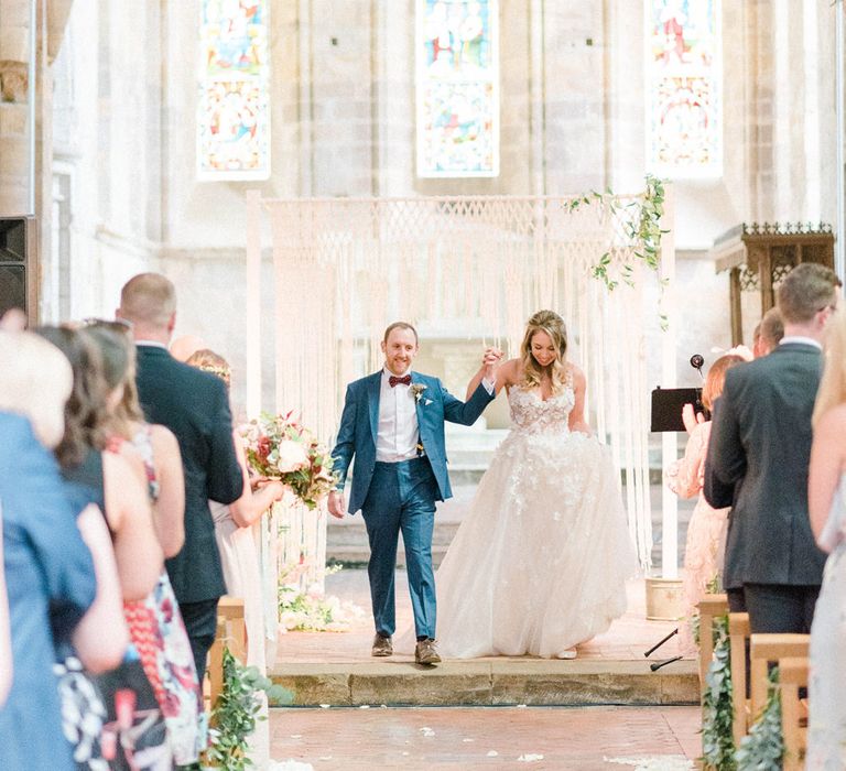 Just Married | Bride in Strapless Liz Martinez Ballgown Wedding Dress with Embroidered Flowers | Groom in Navy Blue Suit with Burgundy Braces, Bow Tie and Brogues | Country Tipi Wedding with Macramé Arch and Hanging Flowers | Sarah-Jane Ethan Photography