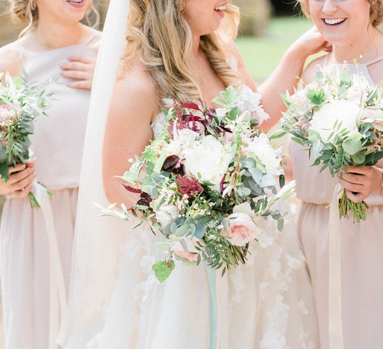 Bride in Strapless Liz Martinez Ballgown Wedding Dress with Embroidered Flowers | Cathedral Length Veil in Blush Soft Tulle | Bouquets of White Peonies, Blush Astlibe, Trailing Greenery and Burgundy Eucalyptus | Bridesmaids in Blush Pink Rita Roushdy Dresses | Country Tipi Wedding with Macramé Arch and Hanging Flowers | Sarah-Jane Ethan Photography