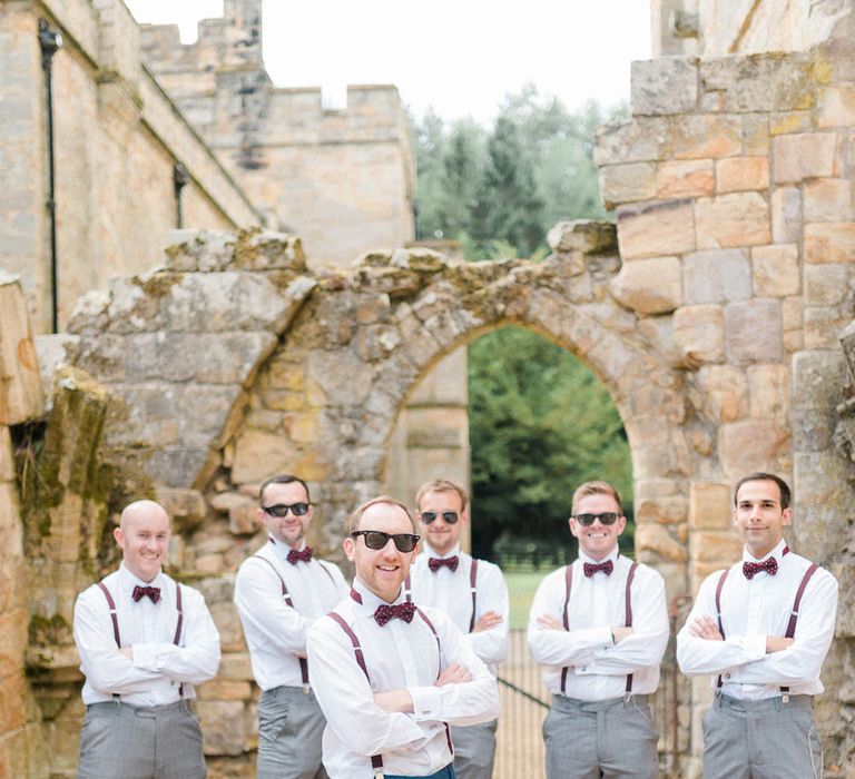 Groom in Navy Blue Suit with Burgundy Braces, Bow Tie and Brogues | Groomsmen in Grey Suits with Burgundy Braces, Bow Ties and Brogues | Country Tipi Wedding with Macramé Arch and Hanging Flowers | Sarah-Jane Ethan Photography