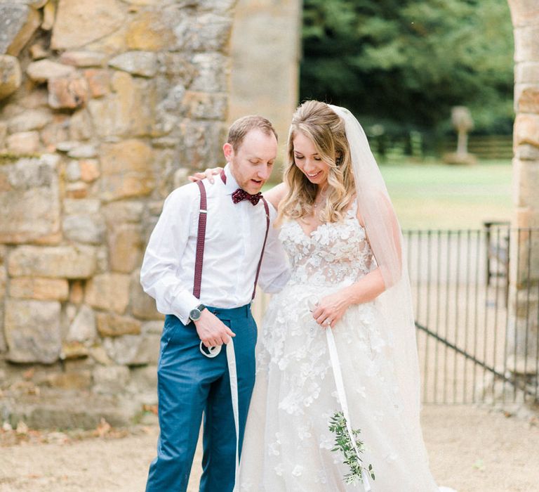 Miniature Schnauzer Ring Bearers in Burgundy Bow Ties | Bride in Strapless Liz Martinez Ballgown Wedding Dress with Embroidered Flowers | Groom in Navy Blue Suit with Burgundy Braces, Bow Tie and Brogues | Country Tipi Wedding with Macramé Arch and Hanging Flowers | Sarah-Jane Ethan Photography