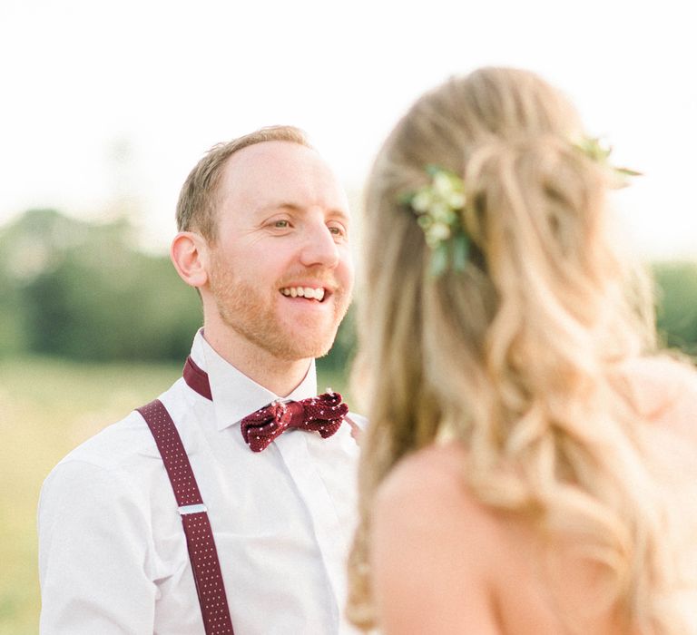 Bride in Strapless Liz Martinez Ballgown Wedding Dress with Embroidered Flowers | Groom in Navy Blue Suit with Burgundy Braces, Bow Tie and Brogues | Country Tipi Wedding with Macramé Arch and Hanging Flowers | Sarah-Jane Ethan Photography