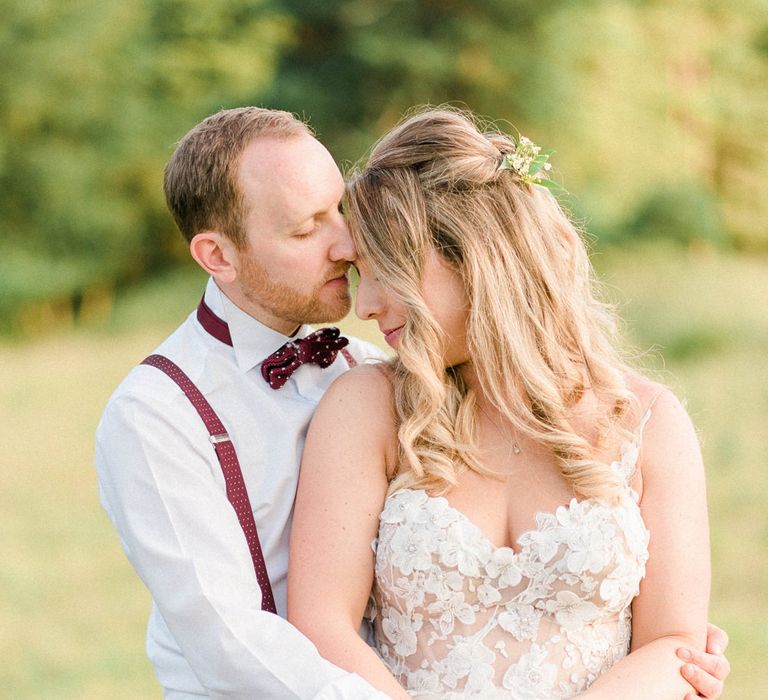 Bride in Strapless Liz Martinez Ballgown Wedding Dress with Embroidered Flowers | Groom in Navy Blue Suit with Burgundy Braces, Bow Tie and Brogues | Country Tipi Wedding with Macramé Arch and Hanging Flowers | Sarah-Jane Ethan Photography