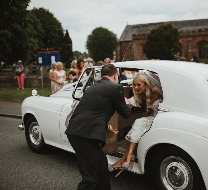 Bride Gets Out Of White Wedding Car At Church