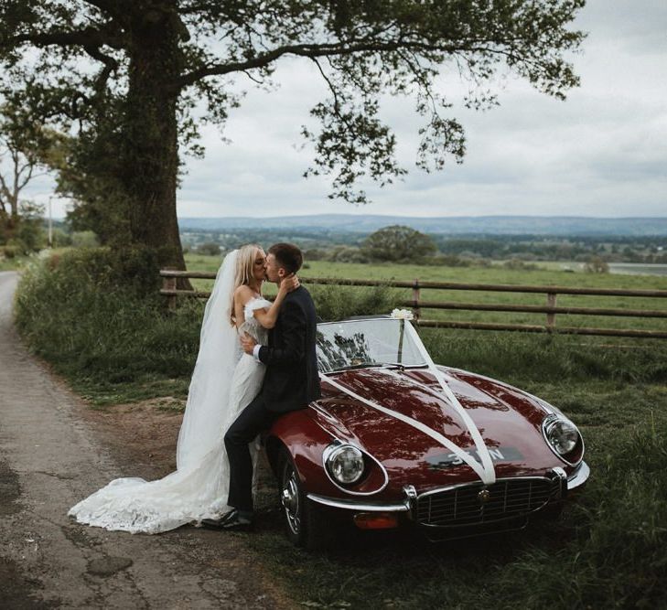 Bride And Groom Kiss On Vintage Car