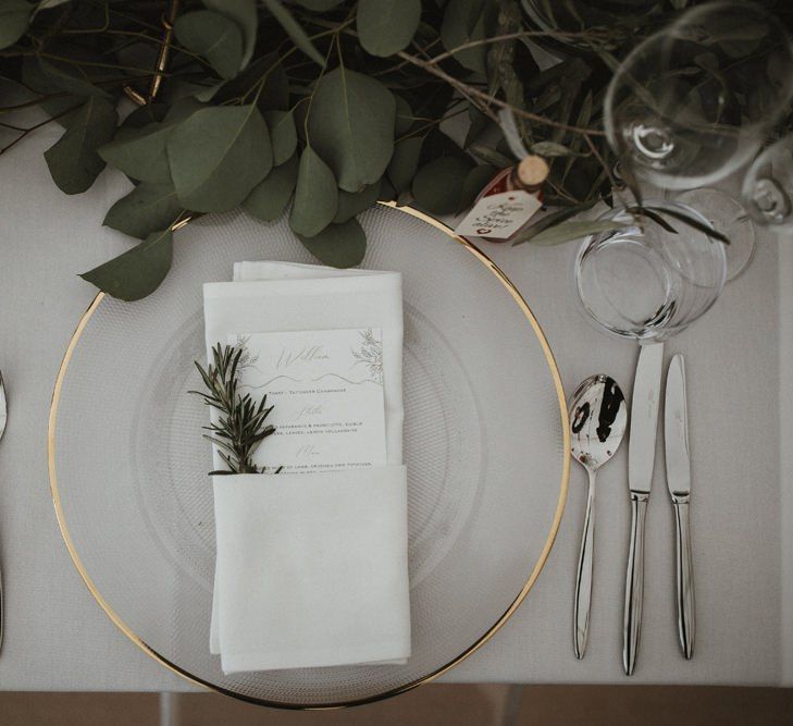 Wedding Table Place Setting With Gold Rimmed Plate and Foliage Decor