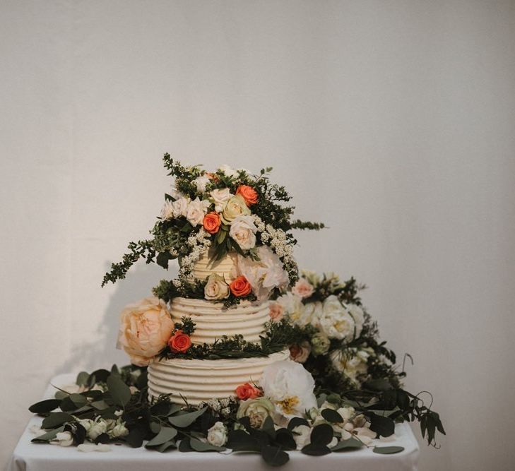 Tiered Wedding Cake Decorated with Flowers and Foliage